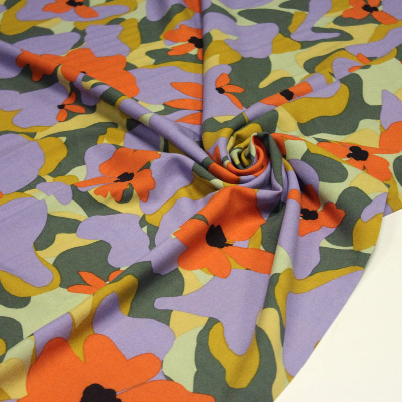 Tissu Viscose fluide AIMEE aux fleurs graphiques vertes, oranges et mauves - OEKO - TEX STANDARD 100 - tissuspipi.com