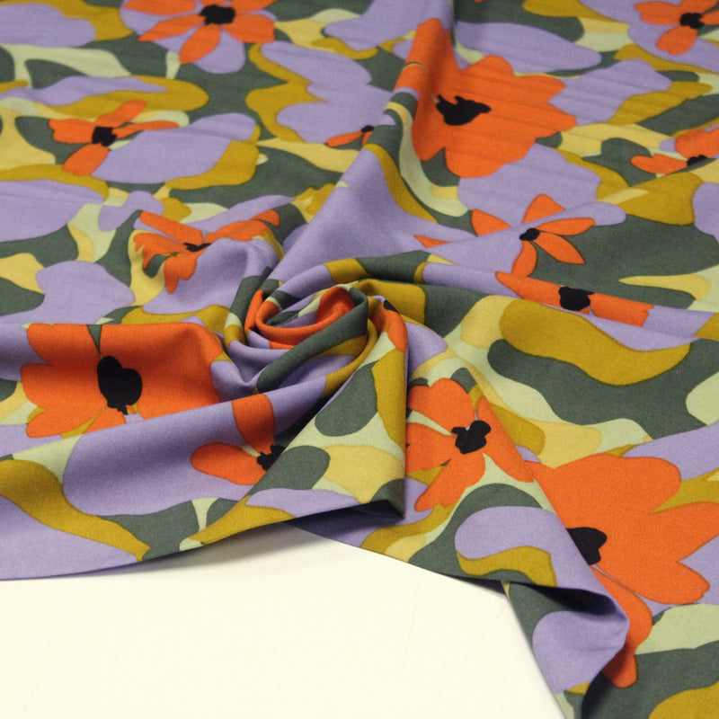 Tissu Viscose fluide AIMEE aux fleurs graphiques vertes, oranges et mauves - OEKO - TEX STANDARD 100 - tissuspipi.com