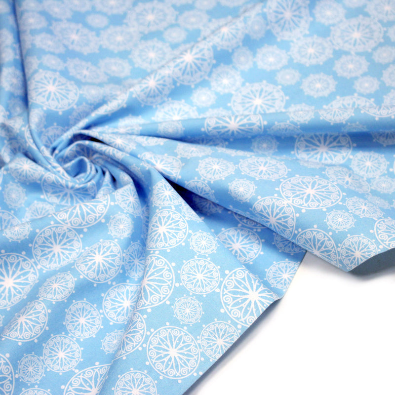 Tissu de Noël cotonnade bleu ciel aux rosaces blanches - tissuspipi.com