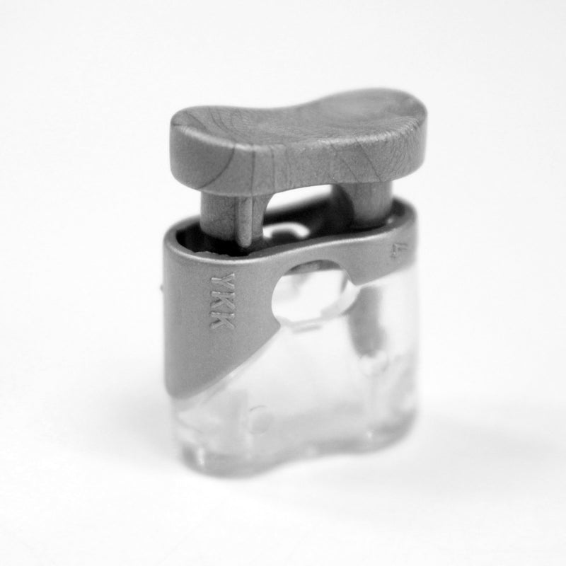Bloque cordon YKK - Stop cordon gris clair & transparent, 1 trou, YKK - tissuspipi.com