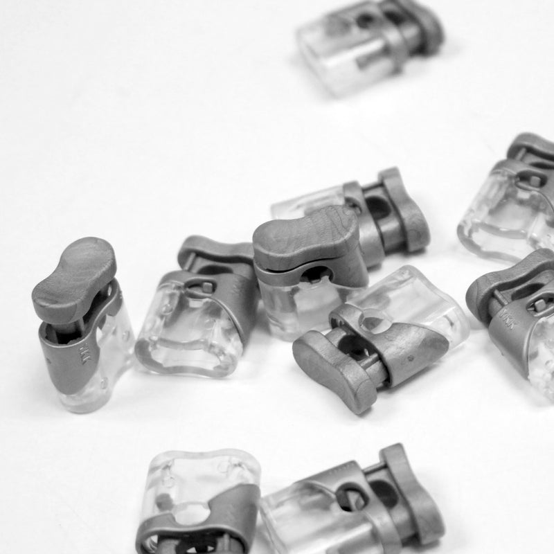 Bloque cordon YKK - Stop cordon gris clair & transparent, 1 trou, YKK - tissuspipi.com