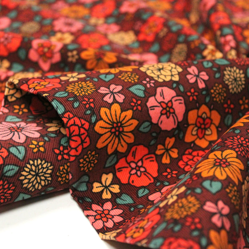 Tissu velours milleraies imprimé SEVENTIES choco aux fleurs rouge roses oranges - STANDARD 100 OEKO-TEX - tissuspipi.com