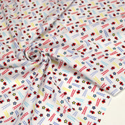 Tissu cotonnade enfant motif pompiers, échelles et étoiles multicolores sur fond blanc - tissuspipi.com