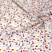 Tissu cotonnade enfant motif pompiers, échelles et étoiles multicolores sur fond blanc - tissuspipi.com