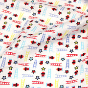 Tissu cotonnade enfant motif pompiers, échelles et étoiles multicolores sur fond blanc - tissuspipi.com