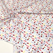 Tissu cotonnade enfant motif pompiers, échelles et étoiles multicolores sur fond blanc - tissuspipi.com