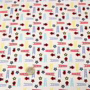Tissu cotonnade enfant motif pompiers, échelles et étoiles multicolores sur fond blanc - tissuspipi.com