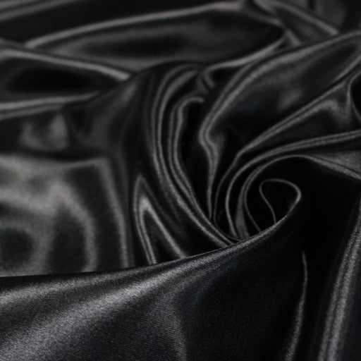 Tissu satin polyester noir uni, fabrication italienne - tissuspipi.com