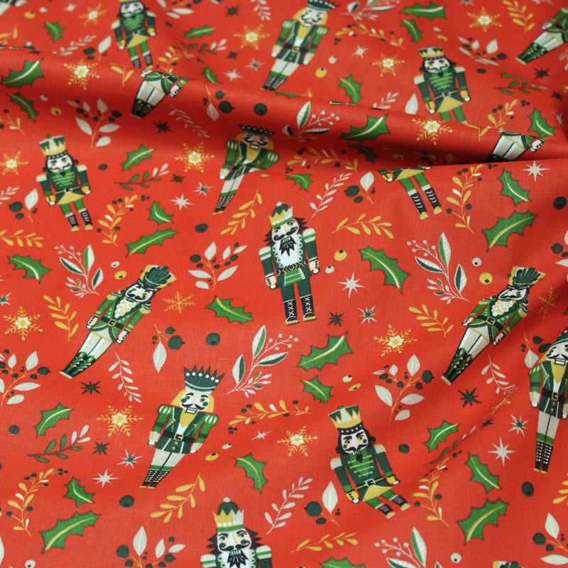 Tissu cotonnade de NOËL, Casse-noisettes, houx et feuillages ocres, fond rouge - OEKO-TEX STANDARD 100 - tissuspipi.com