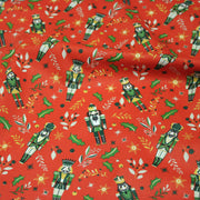 Tissu cotonnade de NOËL, Casse-noisettes, houx et feuillages ocres, fond rouge - OEKO-TEX STANDARD 100 - tissuspipi.com