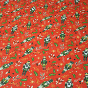 Tissu cotonnade de NOËL, Casse-noisettes, houx et feuillages ocres, fond rouge - OEKO-TEX STANDARD 100 - tissuspipi.com
