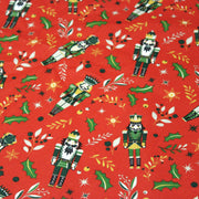 Tissu cotonnade de NOËL, Casse-noisettes, houx et feuillages ocres, fond rouge - OEKO-TEX STANDARD 100 - tissuspipi.com