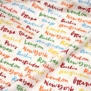 Tissu popeline coton blanc aux noms de ville multicolores, collection VOYAGE - tissuspipi.com