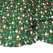 Tissu cotonnade de NOËL – Gnomes, cadeaux et fleurs de Noël, fond vert - OEKO-TEX STANDARD 100 - tissuspipi.com