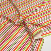 Tissu Bayadère de coton aux rayures oranges, rouges et roses, fond blanc - tissuspipi.com
