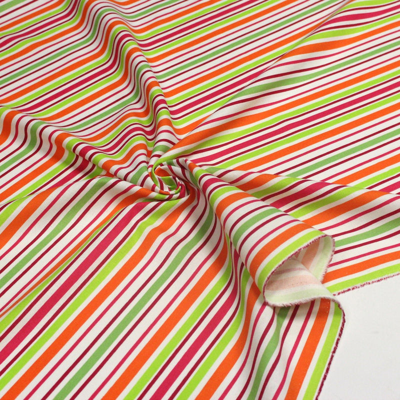 Tissu Bayadère de coton aux rayures oranges, rouges et roses, fond blanc - tissuspipi.com