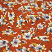 Tissu Viscose crêpe rouille, fleuri blanc & mauve et liserés lurex dorés - tissuspipi.com
