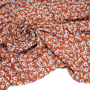 Tissu Viscose crêpe rouille, fleuri blanc & mauve et liserés lurex dorés - tissuspipi.com