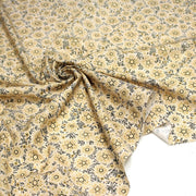 Tissu popeline coton ocre clair aux fleurs & fines arabesques noirs et jaunes - tissuspipi.com