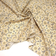 Tissu popeline coton ocre clair aux fleurs & fines arabesques noirs et jaunes - tissuspipi.com