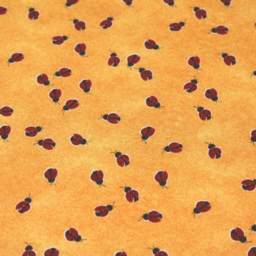 Tissu popeline de coton aux petites coccinelles rouges, fond jaune safran - tissuspipi.com