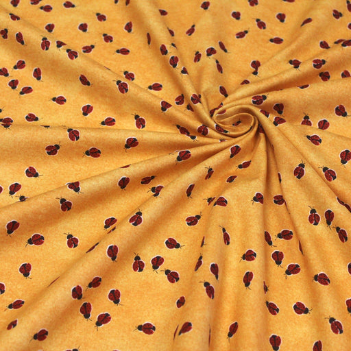 Tissu popeline de coton aux petites coccinelles rouges, fond jaune safran - tissuspipi.com