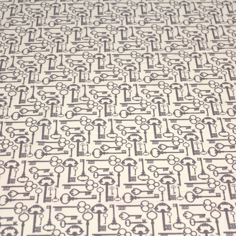 Tissu popeline de coton aux clefs vintage taupe, fond écru - tissuspipi.com