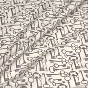 Tissu popeline de coton aux clefs vintage taupe, fond écru - tissuspipi.com