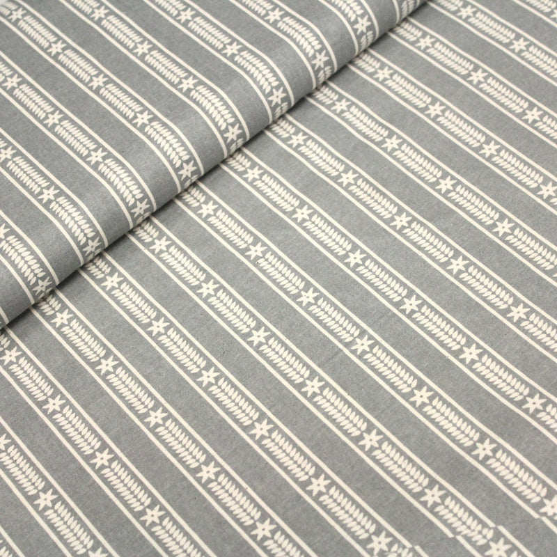 Tissu de coton de Noël scandinave aux étoiles de neiges écrues, fond gris - tissuspipi.com