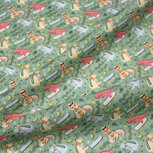 Tissu de coton Dinosaure music lover, fond vert sauge - Oeko - Tex - tissuspipi.com