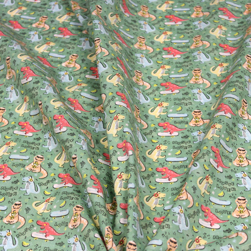 Tissu de coton Dinosaure music lover, fond vert sauge - Oeko - Tex - tissuspipi.com