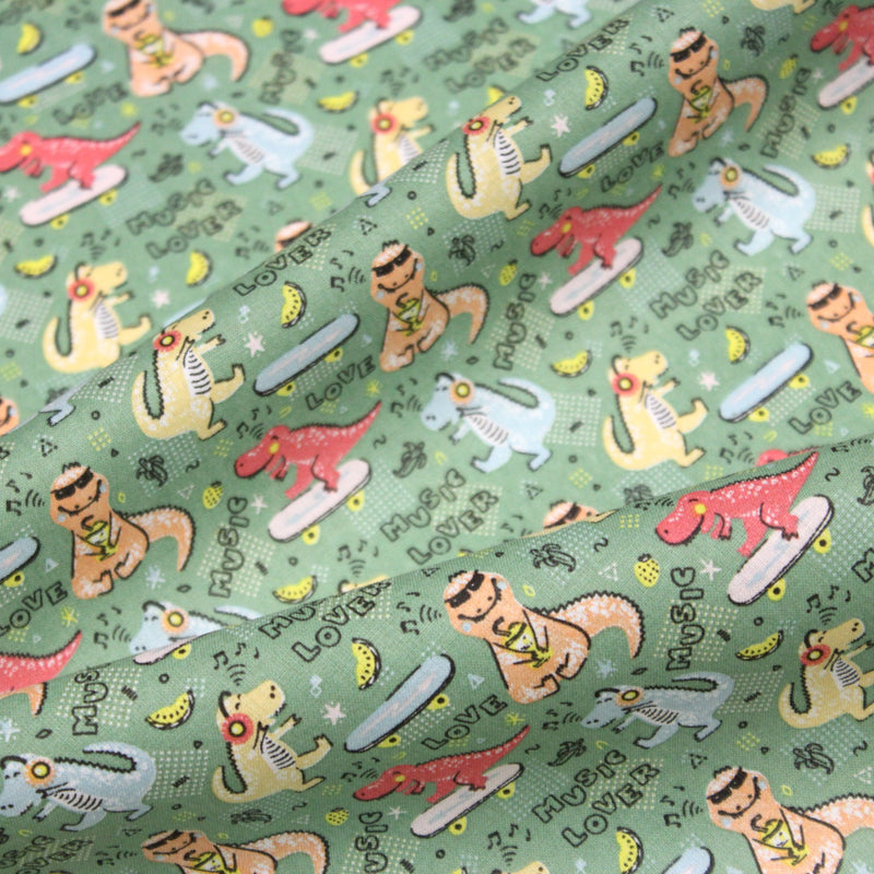 Tissu de coton Dinosaure music lover, fond vert sauge - Oeko - Tex - tissuspipi.com